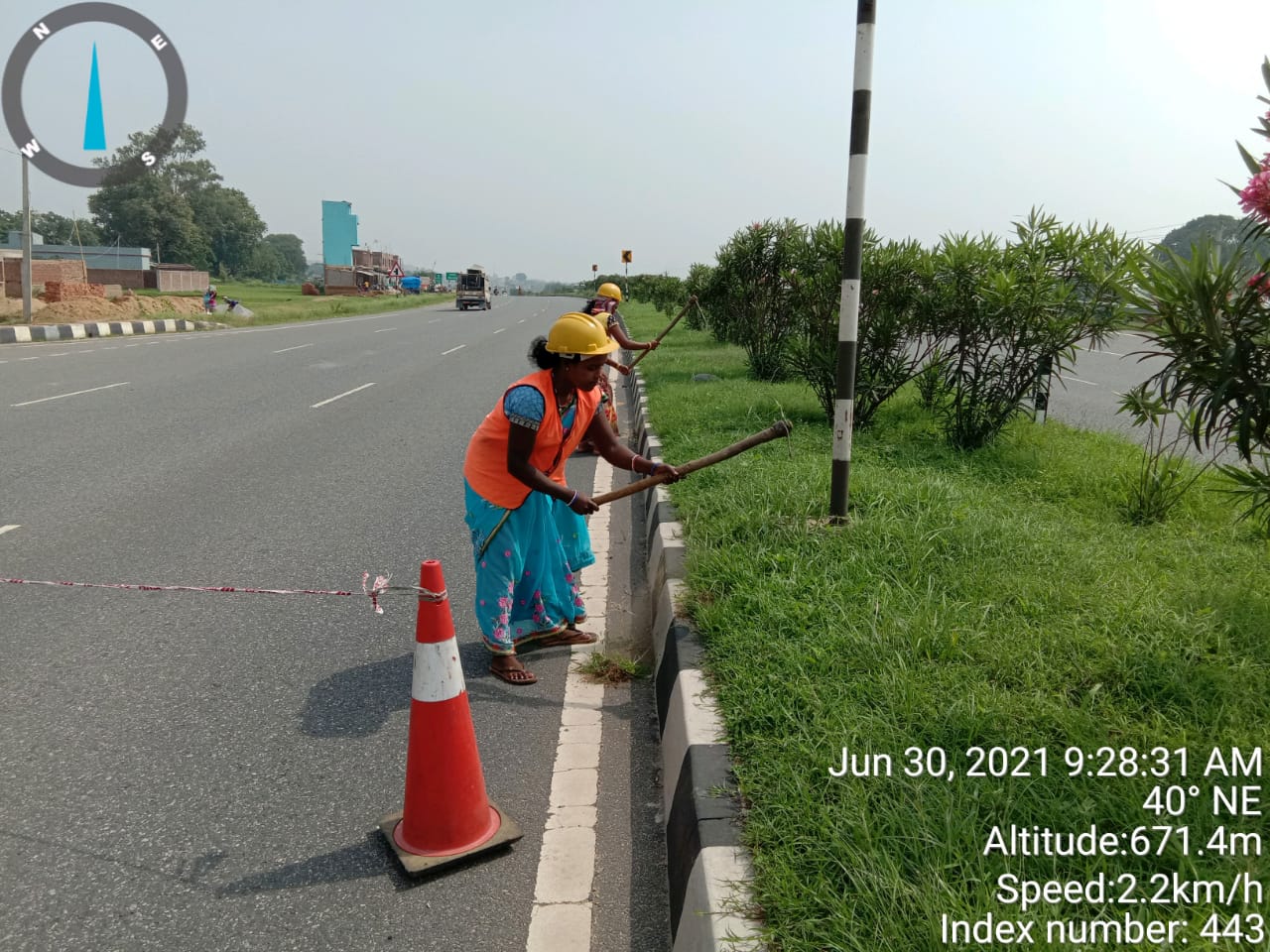 Workers maintaining road median